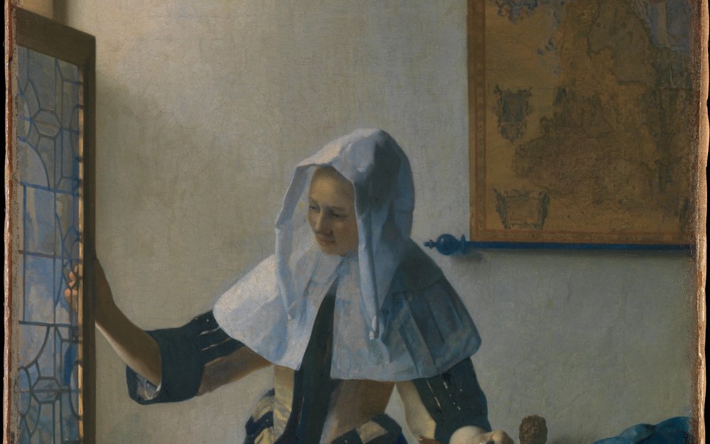ヨハネス・フェルメール《水差しを持つ若い女》（1662年頃）、メトロポリタン美術館。白い頭巾の女性が、窓に手をかけている油彩画の一部。