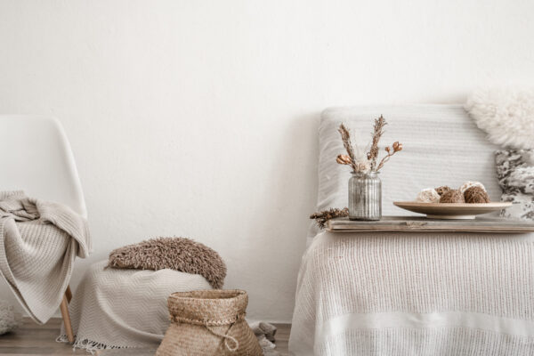 Modern interior in the living room with household items and sofa . Bright room with details of home decor.